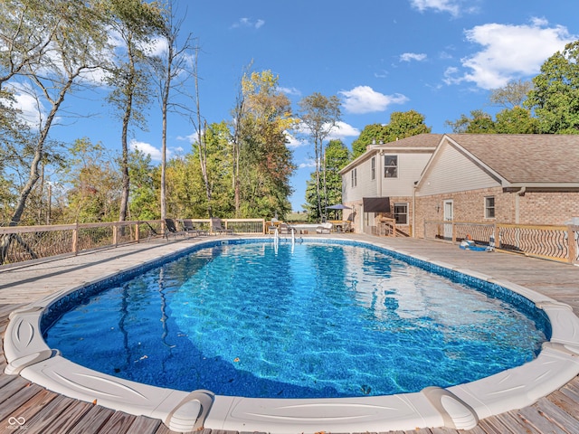 view of swimming pool with a wooden deck