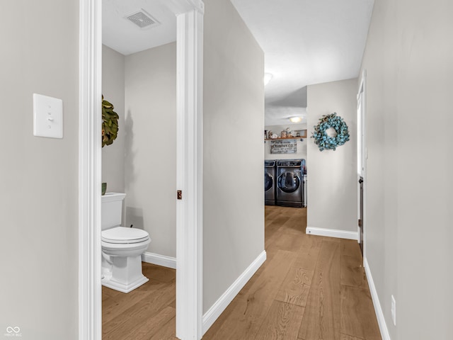 hallway featuring washing machine and dryer and light wood-type flooring