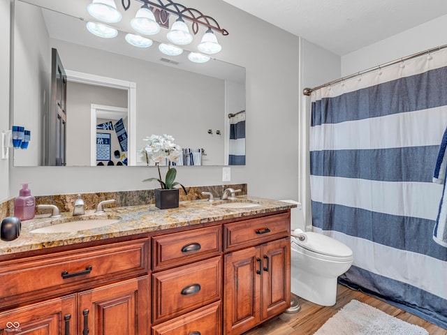 bathroom featuring hardwood / wood-style flooring, toilet, vanity, and a shower with shower curtain