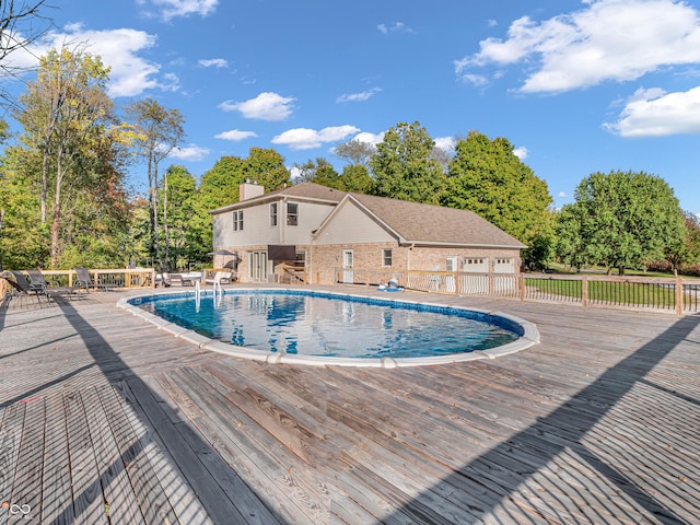 view of swimming pool with a deck