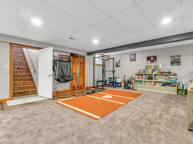 workout room with a drop ceiling and carpet floors