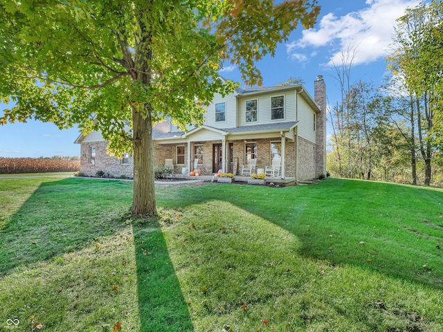 view of front of property with covered porch and a front yard