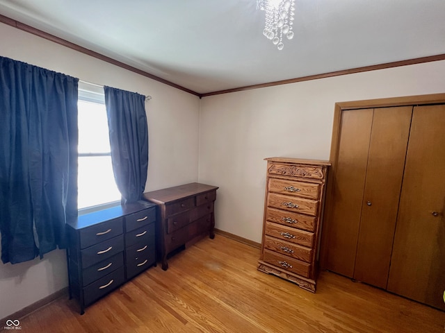 bedroom featuring ornamental molding, light hardwood / wood-style flooring, and a closet