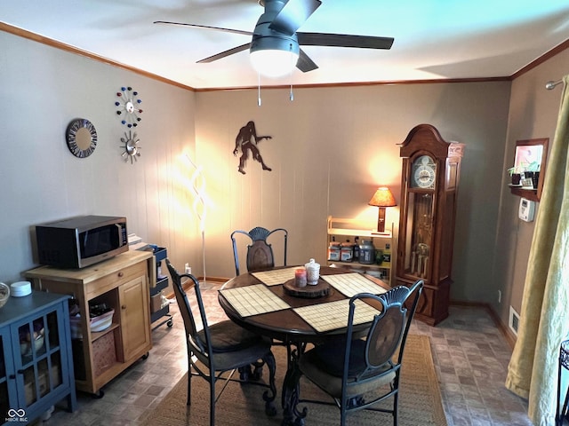 dining space featuring crown molding and ceiling fan