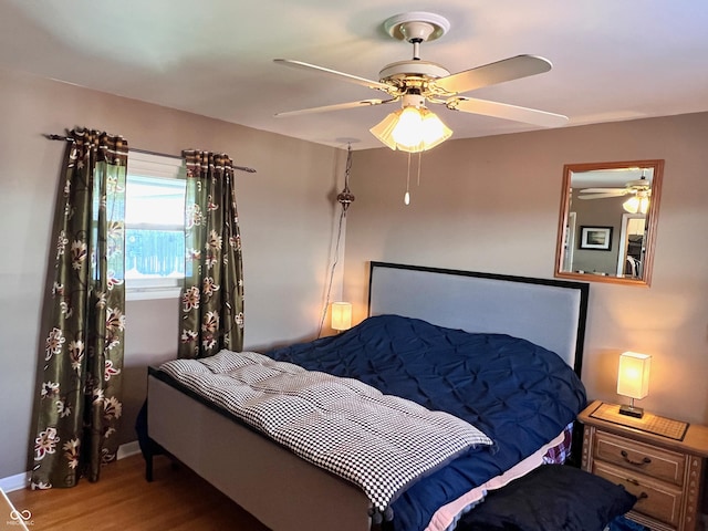 bedroom featuring wood-type flooring and ceiling fan