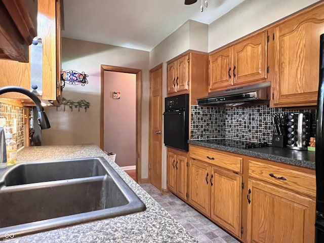 kitchen with sink, backsplash, black appliances, and ceiling fan