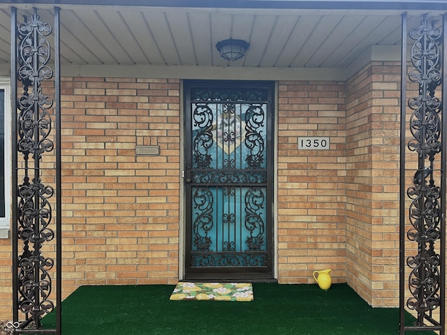 property entrance featuring brick siding