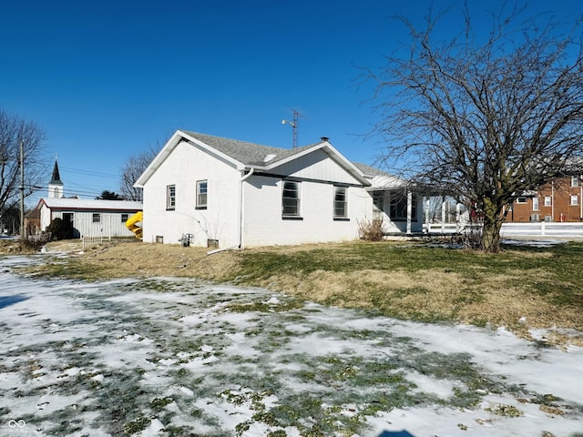 view of snowy exterior featuring a yard