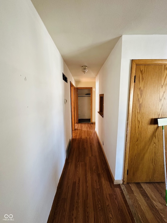 hallway with dark wood-type flooring