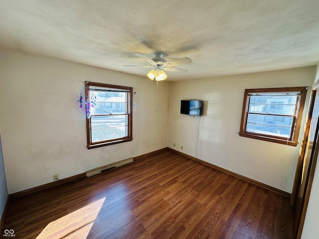 spare room featuring ceiling fan, a textured ceiling, and dark hardwood / wood-style floors