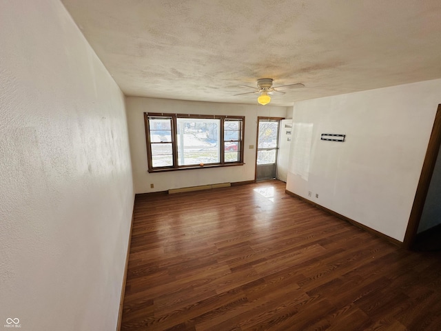 spare room featuring dark wood-type flooring and ceiling fan