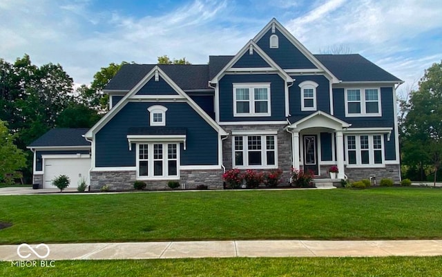 craftsman-style home featuring a garage and a front lawn