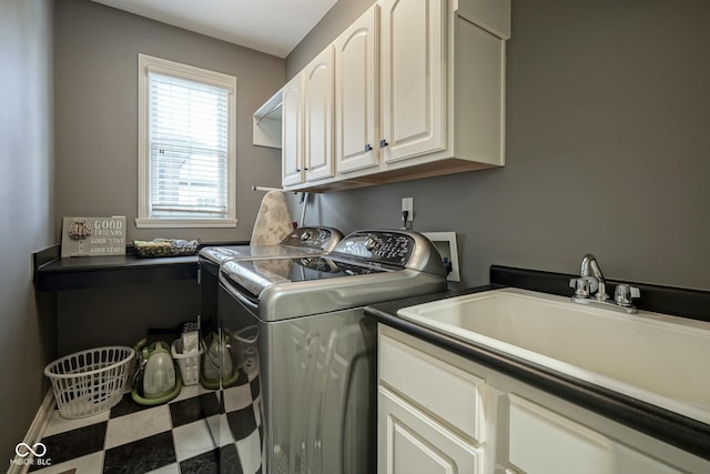 laundry room featuring sink, cabinets, and washer and clothes dryer