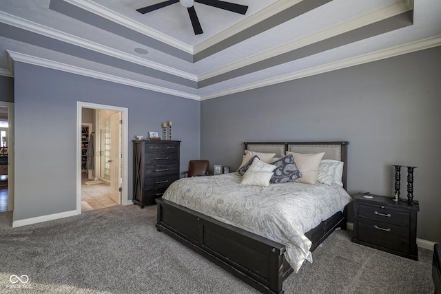 bedroom with carpet flooring, a raised ceiling, ceiling fan, and ornamental molding