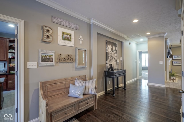 living area with dark wood-type flooring, a textured ceiling, and crown molding