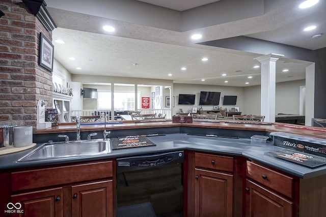 kitchen featuring sink, decorative columns, a textured ceiling, and dishwasher