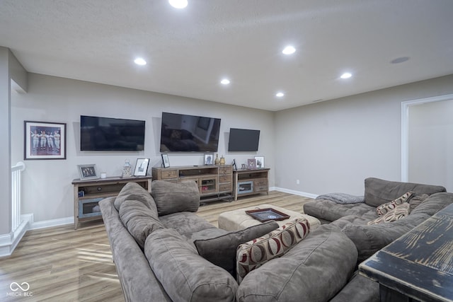 living room featuring a textured ceiling and light wood-type flooring