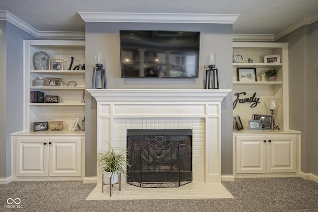 living room with a brick fireplace, built in shelves, ornamental molding, and light carpet