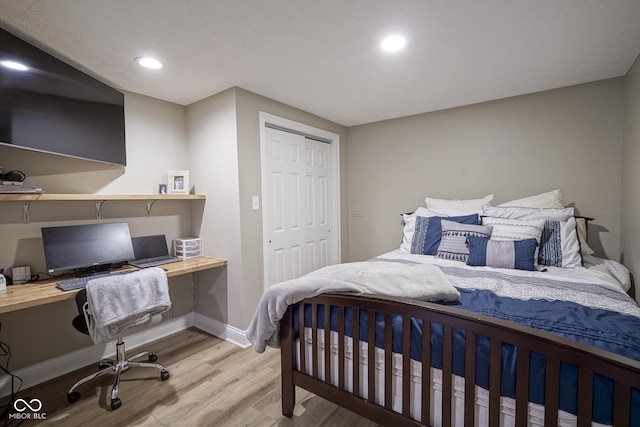 bedroom with a closet and light hardwood / wood-style flooring