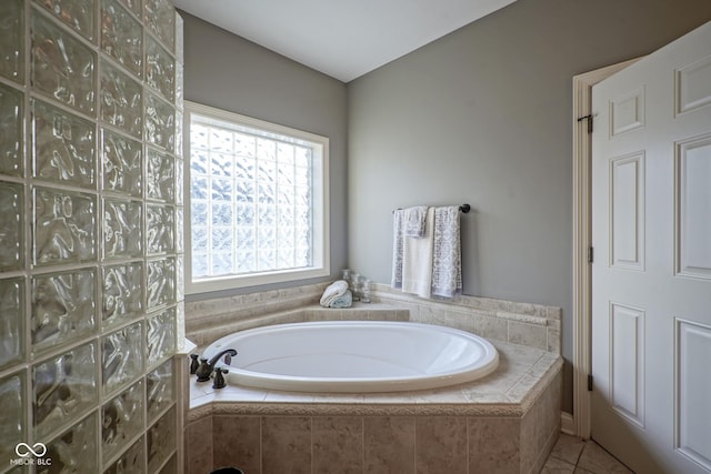 bathroom featuring tiled bath and tile patterned floors