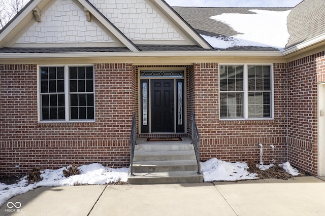 view of snow covered property entrance