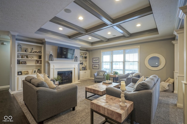 carpeted living room with beamed ceiling, coffered ceiling, a brick fireplace, built in shelves, and ornamental molding