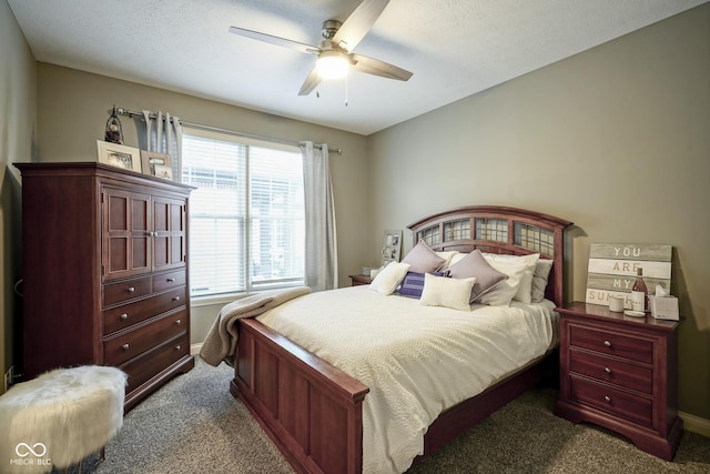 bedroom with dark carpet, multiple windows, and ceiling fan