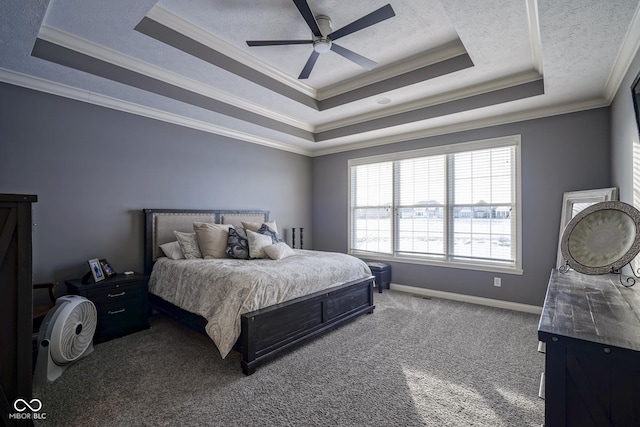 carpeted bedroom with ceiling fan, ornamental molding, and a tray ceiling