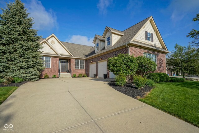 16395 La Paloma Ct, Noblesville, IN 46060 - view of front facade featuring a shingled roof, an attached garage, a front lawn, brick siding, and driveway