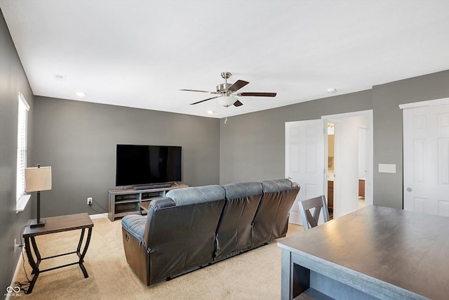 carpeted living room featuring ceiling fan