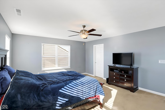 bedroom featuring light carpet and ceiling fan