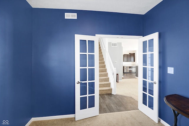 empty room featuring carpet and french doors