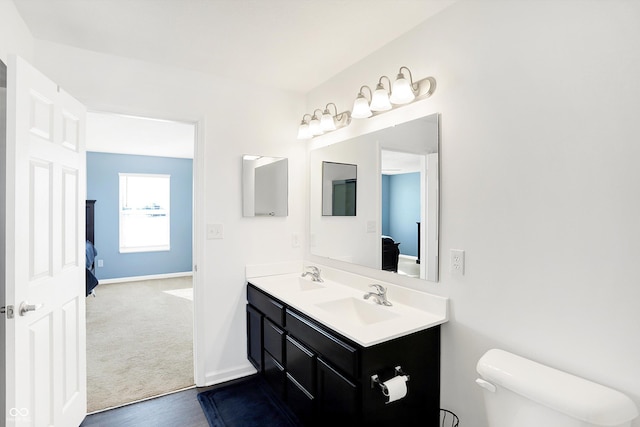 bathroom featuring toilet and vanity