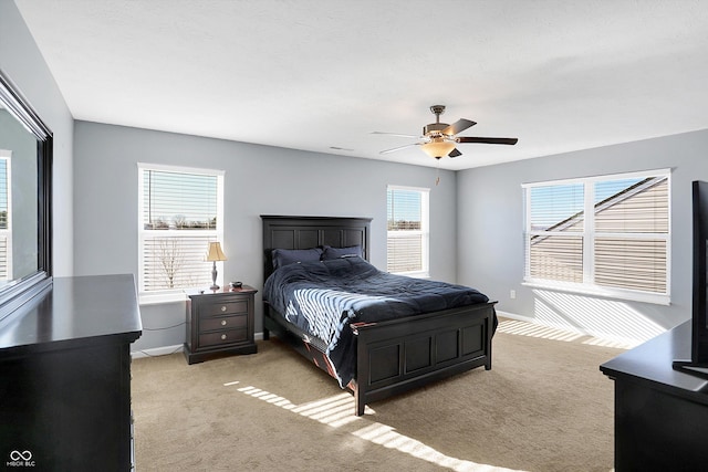 bedroom with light carpet and ceiling fan