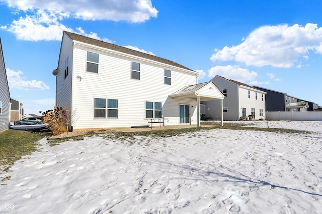 view of snow covered rear of property