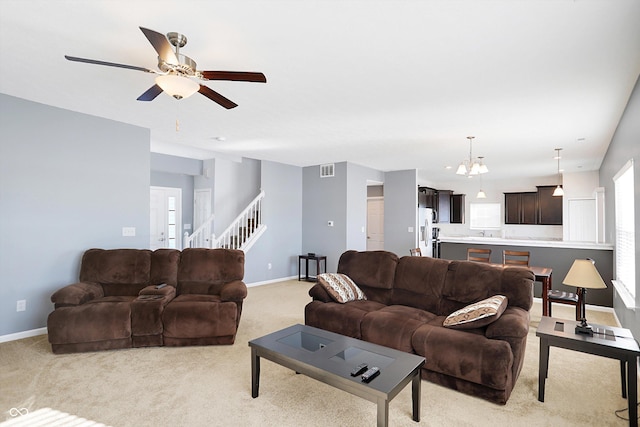 carpeted living room with ceiling fan