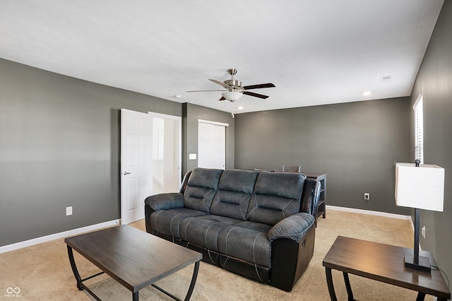 living room featuring light carpet and ceiling fan