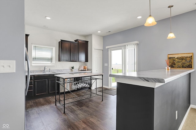 977 Capricorn Dr, Franklin, IN 46131 - kitchen featuring a sink, decorative light fixtures, recessed lighting, dark wood-style floors, and baseboards