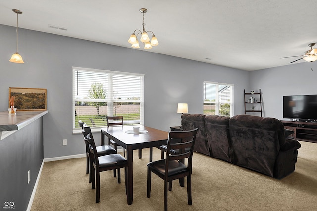977 Capricorn Dr, Franklin, IN 46131 - dining room featuring light carpet, baseboards, ceiling fan with notable chandelier, and visible vents