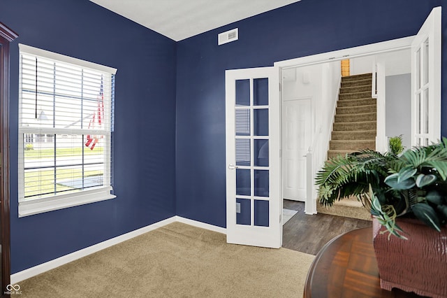 977 Capricorn Dr, Franklin, IN 46131 - unfurnished room featuring visible vents, french doors, baseboards, and stairway