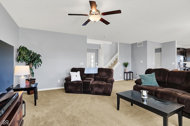 977 Capricorn Dr, Franklin, IN 46131 - living area featuring visible vents, light carpet, a ceiling fan, and stairway