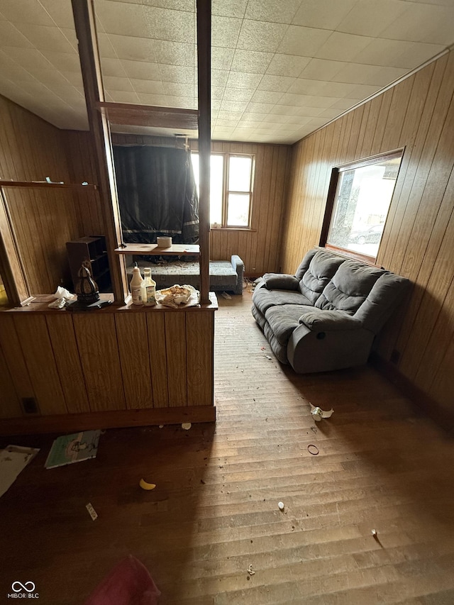 living room featuring wood-type flooring and wood walls