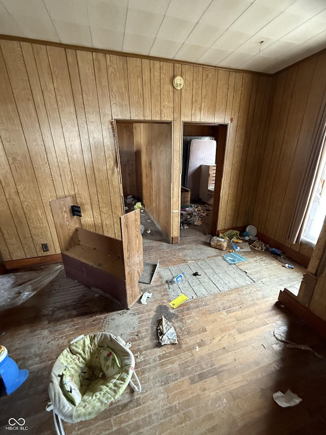 miscellaneous room featuring wood walls