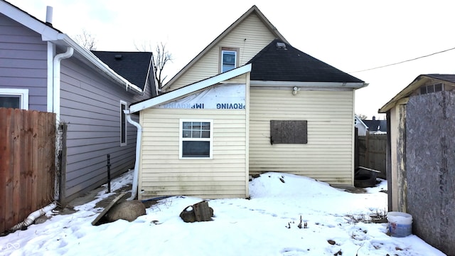 view of snow covered rear of property