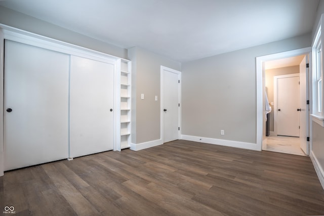 unfurnished bedroom featuring dark hardwood / wood-style flooring