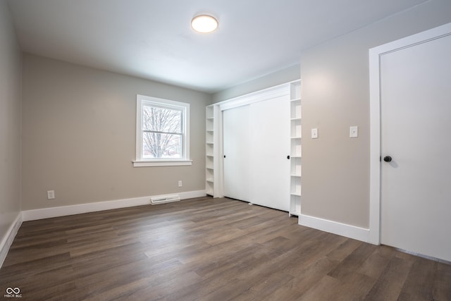 empty room featuring dark wood-type flooring