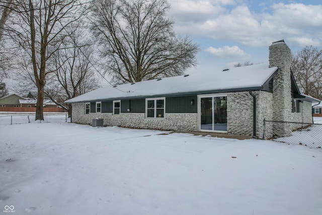 snow covered property featuring central air condition unit