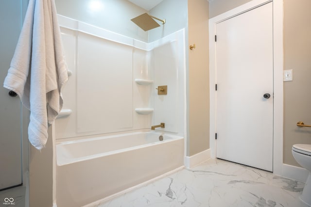 bathroom featuring tub / shower combination and toilet