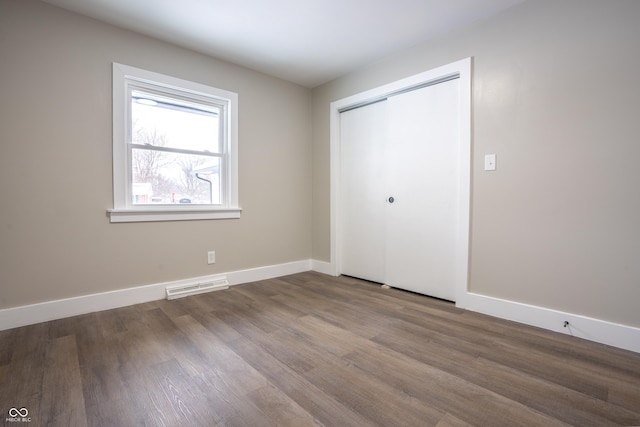 unfurnished bedroom featuring hardwood / wood-style flooring and a closet