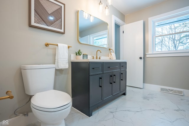 bathroom with toilet and vanity